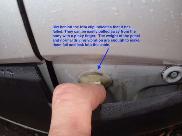 Dirt behind the panel clip indicates failure to seal.